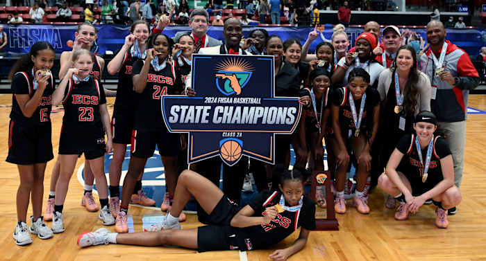 Evangelical Christian Academy get together with their championship trophy after winning the Class 2A girls basketball state championship on Thursday at the RP Funding Center in Lakeland. Evangelical defeated Central Florida Christian Academy.